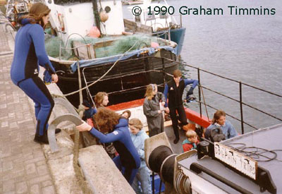 Seventh Wave customers boarding Bruce Flannery’s hastily converted dolphin boat. No pontoons or easy access ramps in 1990!